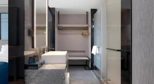 Ένα ή περισσότερα κρεβάτια σε δωμάτιο στο Echarm Hotel Zhuzhou Liling
