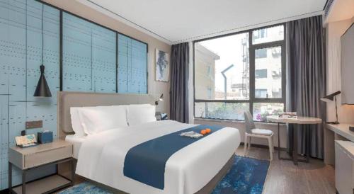 Ένα ή περισσότερα κρεβάτια σε δωμάτιο στο Echarm Hotel Zhuzhou Liling