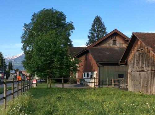an old barn with a mountain in the background at BnB Haag in Haag