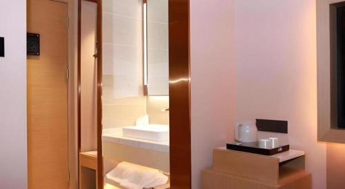 a bathroom with a glass cabinet with a appliance in it at Lavande Hotel Shenzhen East Gate Wanxiang City Guomao Metro Statipn in Shenzhen