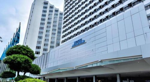 a large building with a sign on the side of it at Hotel Miramar Singapore in Singapore