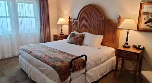 a hotel room with a bed and a table with a lamp at Volcano House in Volcano
