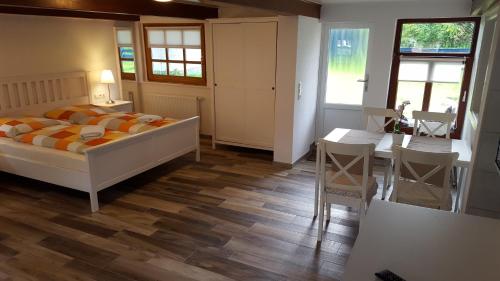 a bedroom with a bed and a table and chairs at Holiday Homes Buchholz in Büsum