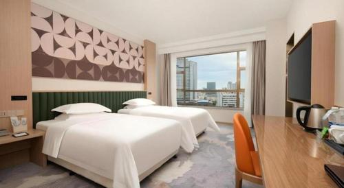 Zhangjiagang Guomao Hotelにあるベッド