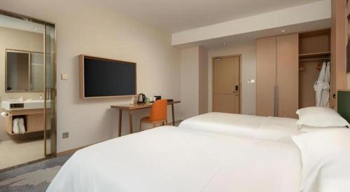 Zhangjiagang Guomao Hotelにあるベッド