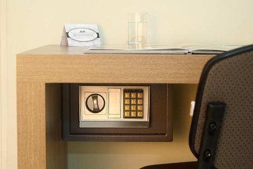a wooden table with a microwave on top of a desk at Monte Serrat Hotel in Santos