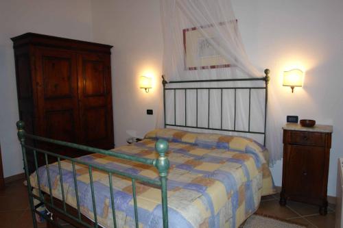 a bedroom with a bed and a wooden dresser at Tenuta Il Tresto in Poggibonsi