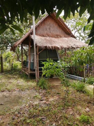 a small hut with a thatched roof at Maloop Camping in Koh Rong Island