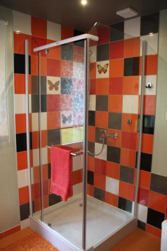 a shower with a glass door in a bathroom at Vējavas in Svettsiyems