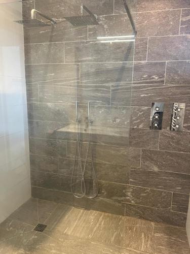 a shower with a glass door in a bathroom at Villa Mauret Plage in Andernos-les-Bains
