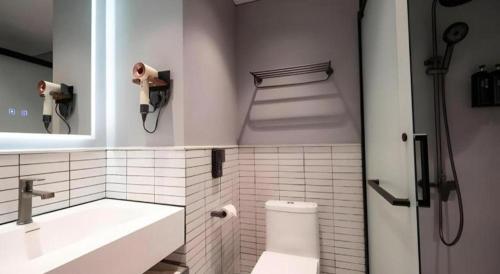 a bathroom with a toilet and a sink and a mirror at Harbour Bay Hotel in Hong Kong