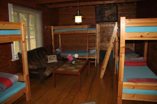 a room with bunk beds and a couch and a table at Vējavas in Svettsiyems