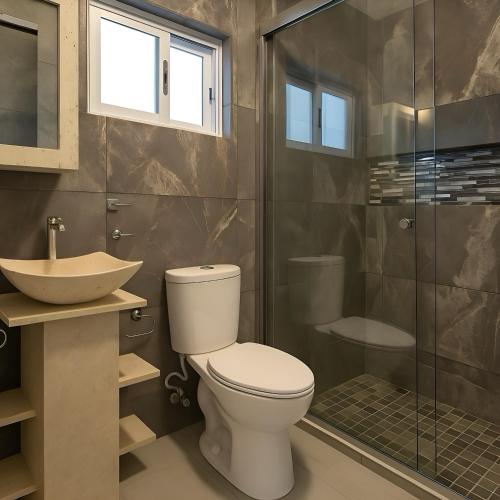 a bathroom with a toilet and a sink and a shower at Suites C O V A D O N G A in Mexico City