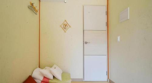 a room with a glass shower door and a couch at Nabijam Hanok Hotel in Jeonju