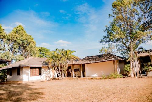 a house with trees in front of it at Gimanhala Visitor Bungalow in Dambulla