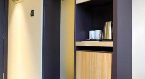 a room with a door with a shelf with books at Ehotel in Hong Kong