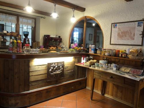 a restaurant with a counter with food on it at Maison Laurent in Courmayeur