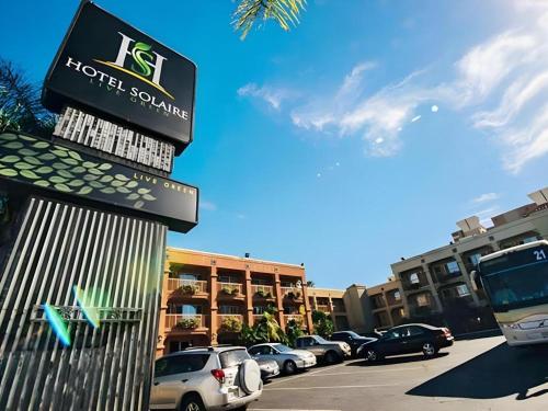 a hotel sodium sign in front of a parking lot at Hotel Solaire Los Angeles in Los Angeles