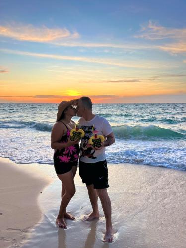 a man and a woman kissing on the beach at Roma beach in Cartagena de Indias