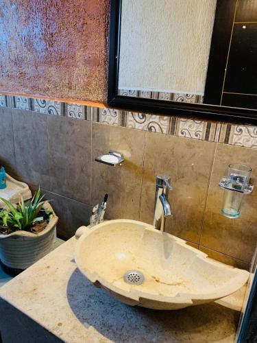 a sink in a bathroom with a counter at El Encanto Residence in Morelia