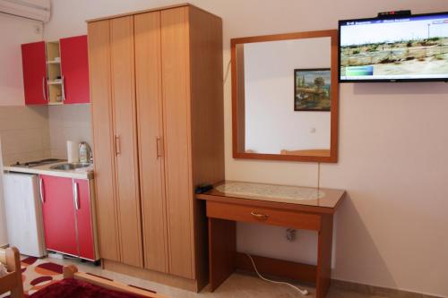 a kitchen with a mirror and a wooden cabinet at Apartments Sija in Ulcinj