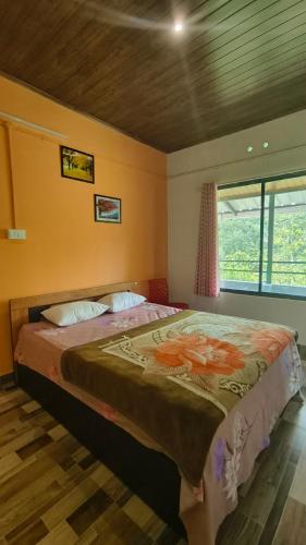 a bedroom with a large bed in a room at ellickall homestay calvarymount in Idukki