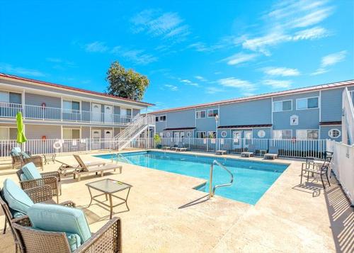 a swimming pool in front of a apartment building at Coastal Shores Condo in Biloxi