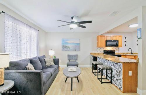 a living room with a couch and a kitchen at Coastal Shores Condo in Biloxi
