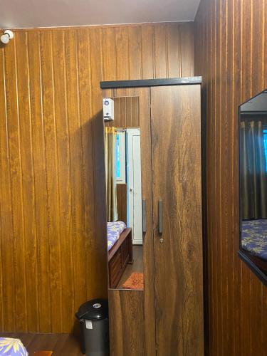 a small room with a door and a mirror at River view villa in Pondicherry