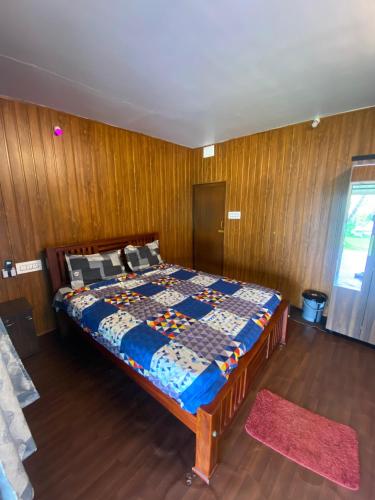 a bedroom with a bed with a wooden wall at River view villa in Pondicherry