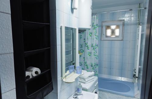 a bathroom with a sink and a toilet and a shower at Garsoniera in Mangalia