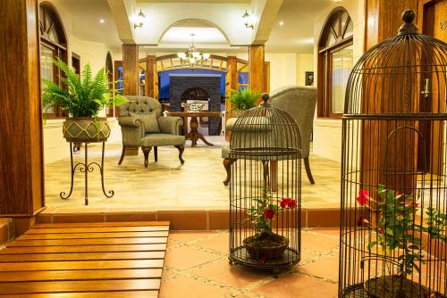 a lobby with two birdcages and a living room at Hotel Rincon de Puembo; BW Signature Collection in Puembo