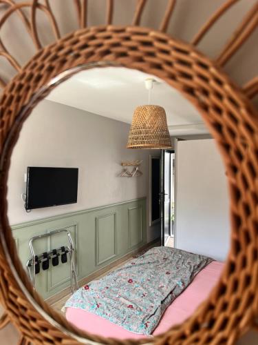 a mirror in a room with a bed and a tv at Au gré des vents in Saint-Quay-Portrieux