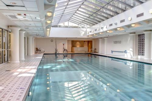 a large swimming pool in a building at Heaven on Washington Fully Furnished Apartments in Washington, D.C.