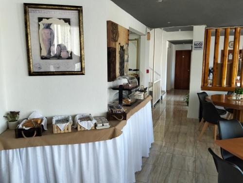 a counter in a restaurant with a table with shoes on it at Hotel Tainaro in Loutra Edipsou