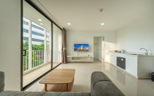 a living room with a couch and a table at SHIN Patara Living Hotel in Bangkok