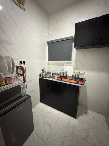 a kitchen with a sink and a counter top at Private Fully Serviced Studio Apartment At Ogudu , AC, Private kitchen and bathroom, Not A Shared, 5 percent off Weekly and 10 percent off Monthly Stays in Lagos