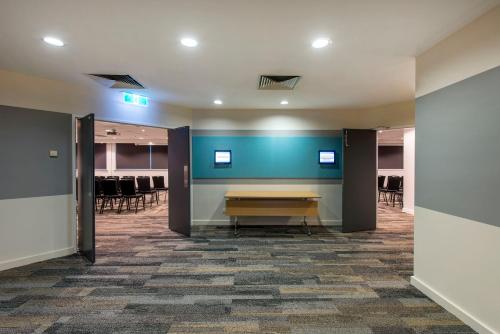 a conference room with a table and chairs at Oaks Perth Hotel in Perth