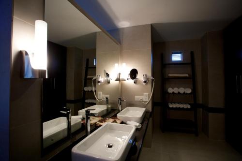 a bathroom with a sink and a mirror at Jetwing Sea in Negombo