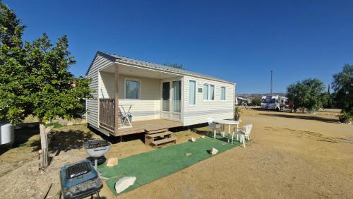 a tiny house with a putting green in a lot at Camping Albox in Albox
