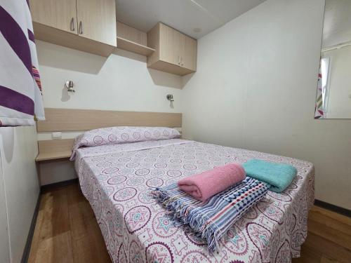 a bedroom with a bed with two pillows on it at Camping Albox in Albox
