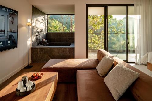 a living room with a couch and a tub at 至也 黄果树 in Xinggong