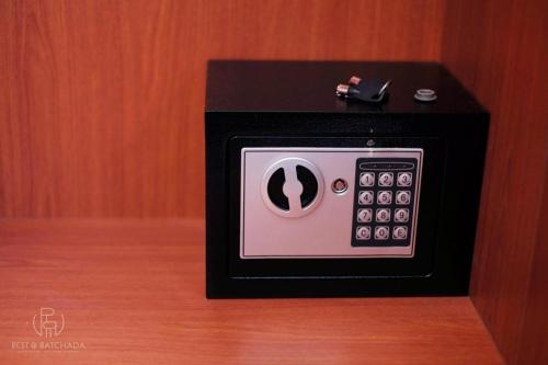 a black and white microwave sitting on top of a table at Rest@Ratchada hotel in Bangkok