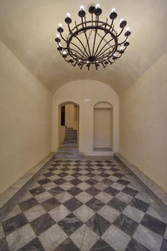 an empty hallway with a chandelier at Casa Argento in Sciacca