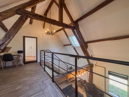 an attic room with a staircase and a desk at Charming Maison de Campagne 
