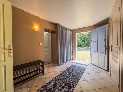 a hallway with a door leading to a room with a window at Charming Maison de Campagne 