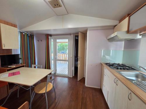 a kitchen with a table and a counter top at Camping Albox in Albox