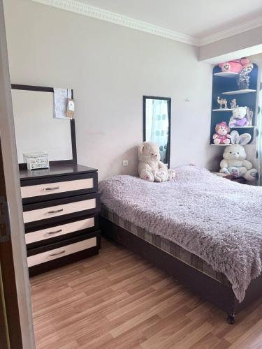 a bedroom with a bed and a dresser and a mirror at SweetHome in Sevan