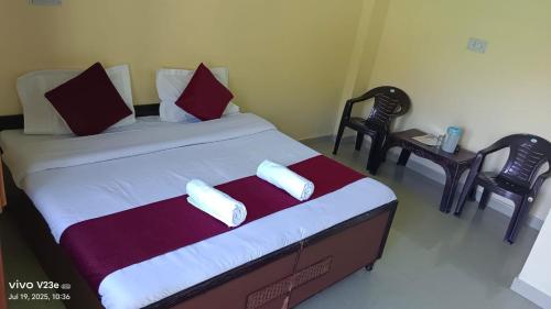 a bedroom with a large bed with two chairs at Hotel Nanak bharmour manimahesh in Brāhmaur