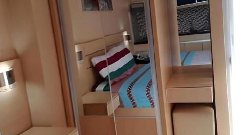 a reflection of a bedroom with a bed in a mirror at Bogor Valley Hotel in Bogor